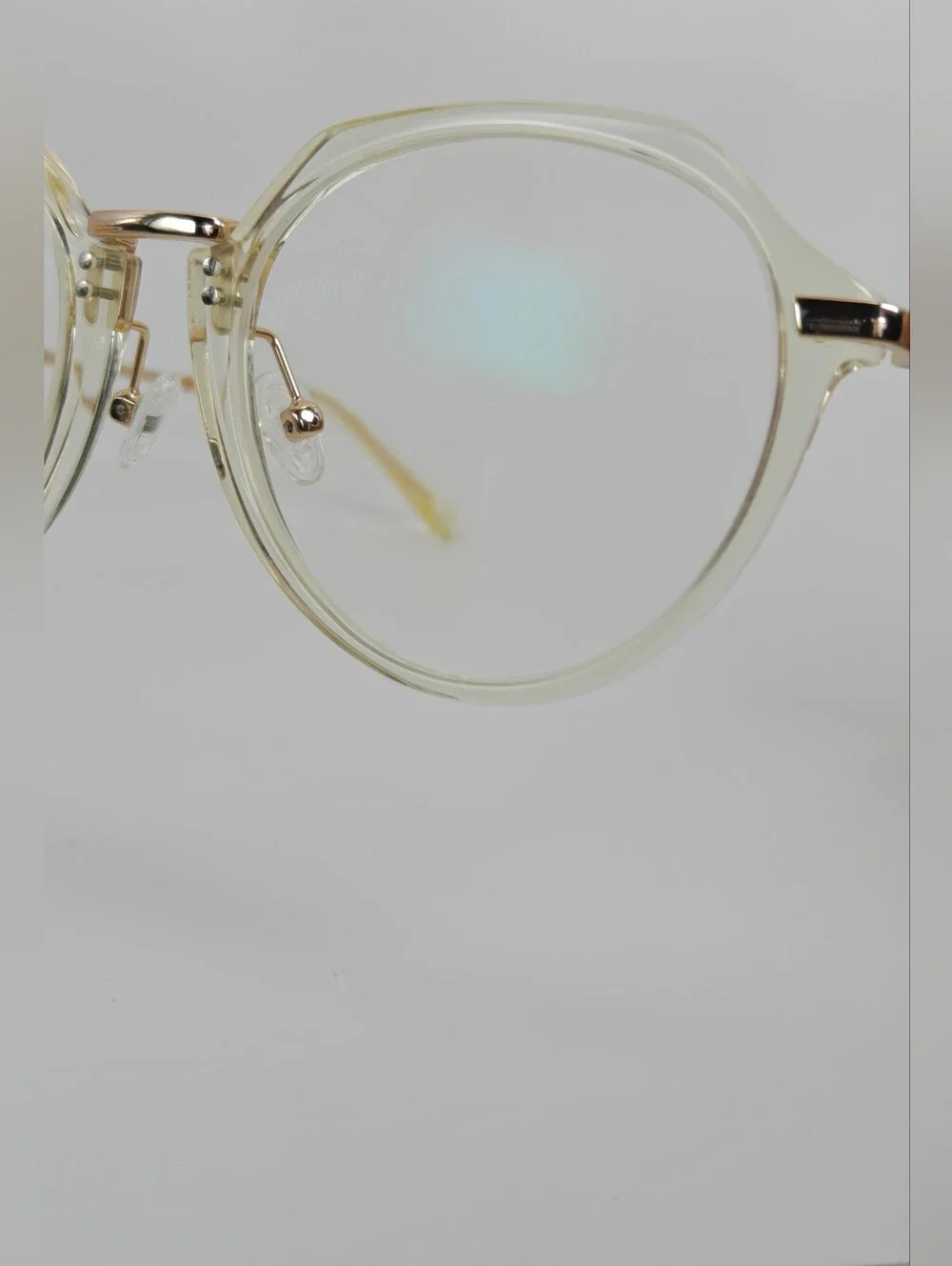Tamara. Clear Round Frame Glasses. All Gold Accents are Metal.